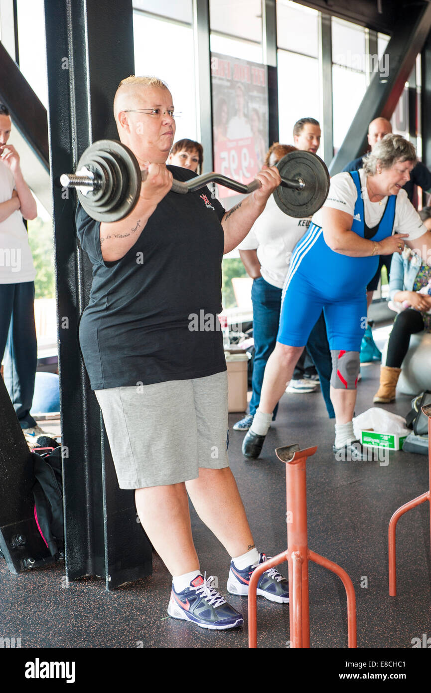 Female contestant performing the strict curl in a world record attempt at the age of sixty at the Dutch grand prix strict curl. Stock Photo