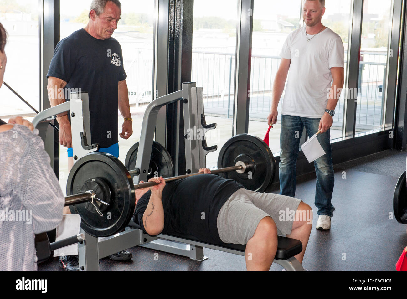 Senior female contestant performing the bench press earning the world title at sixty years of age. Stock Photo