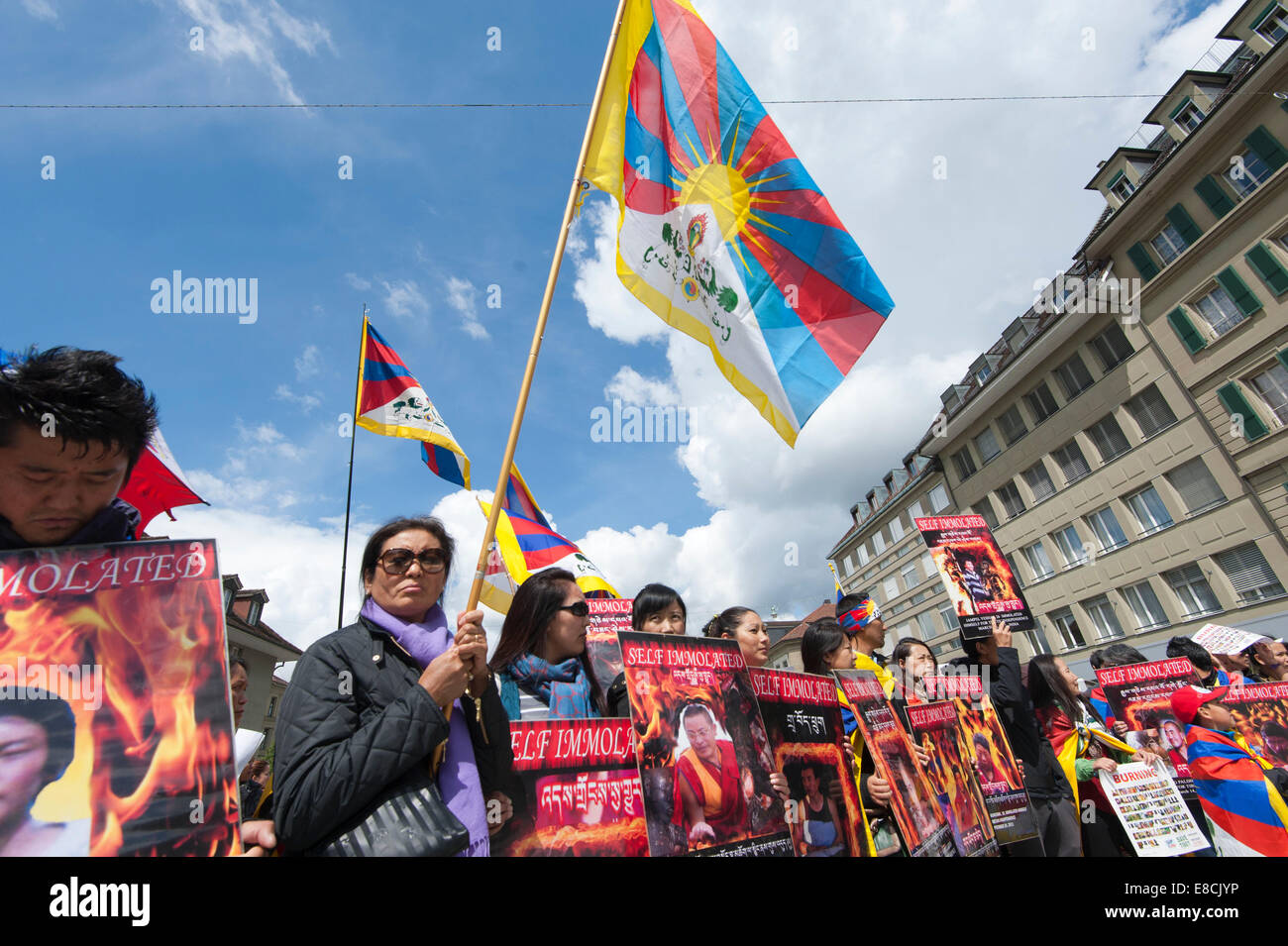 Tibetans are holding up posters and flags at a  protest rally during the visit of China's Premier Li Keqiang in Bern,Switzerland Stock Photo