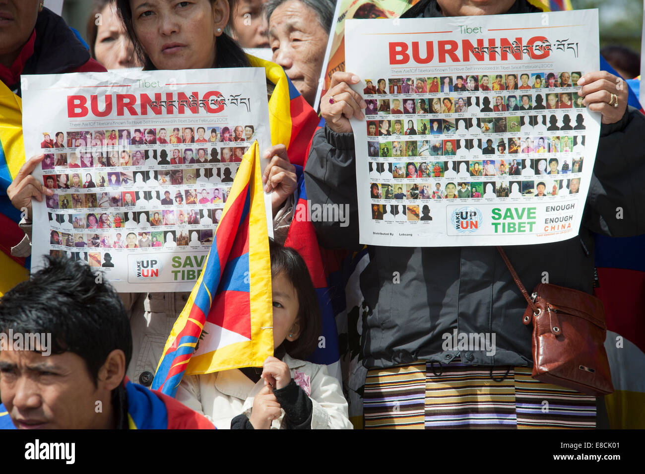 A little Tibetan girl is handling her flag at a protest rally of exile Tibetans in Bern, Switzerland. Stock Photo