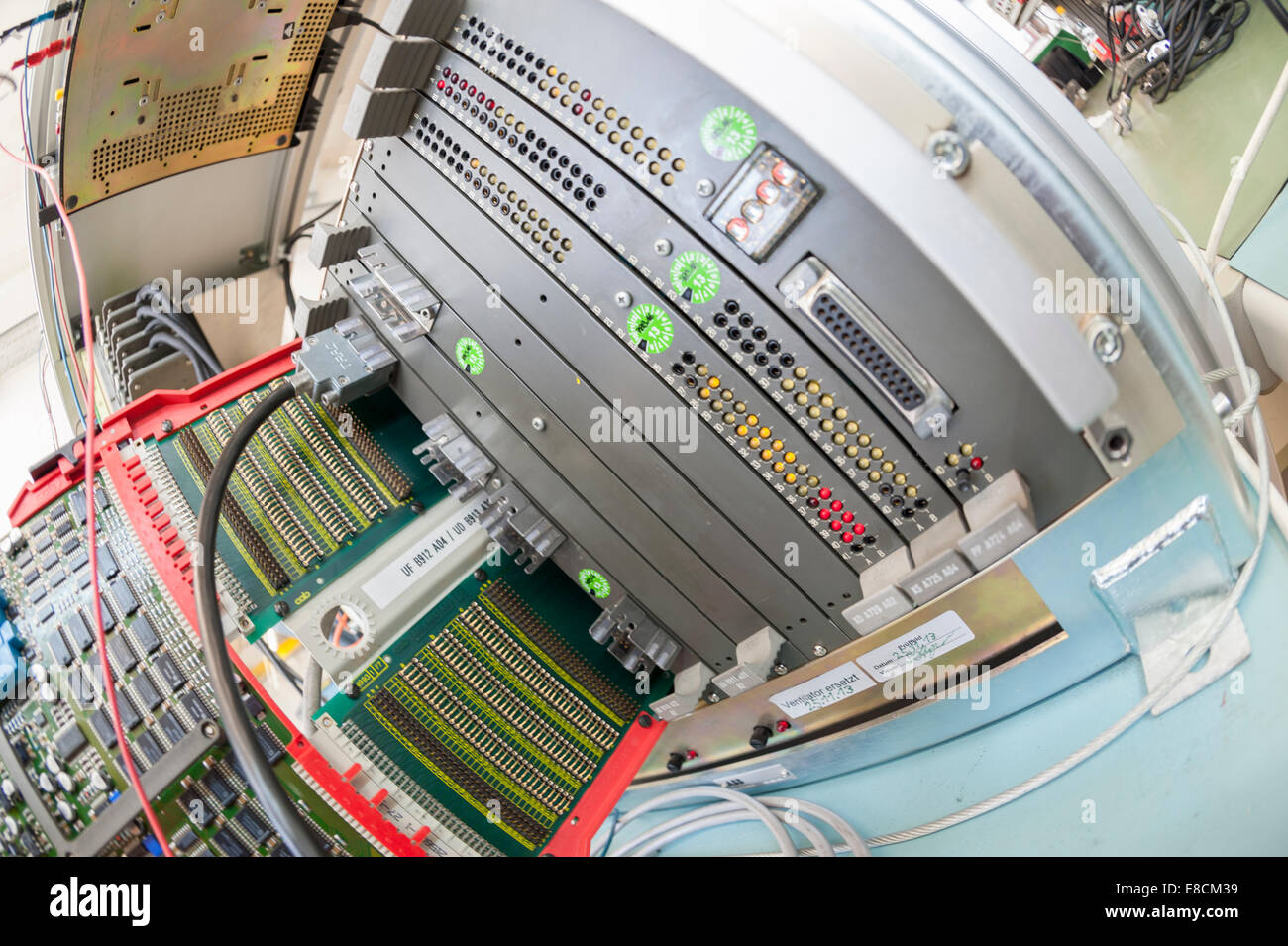 A mother board / microprocessor circuit board is being inserted into a computer test rack for quality assurance Stock Photo