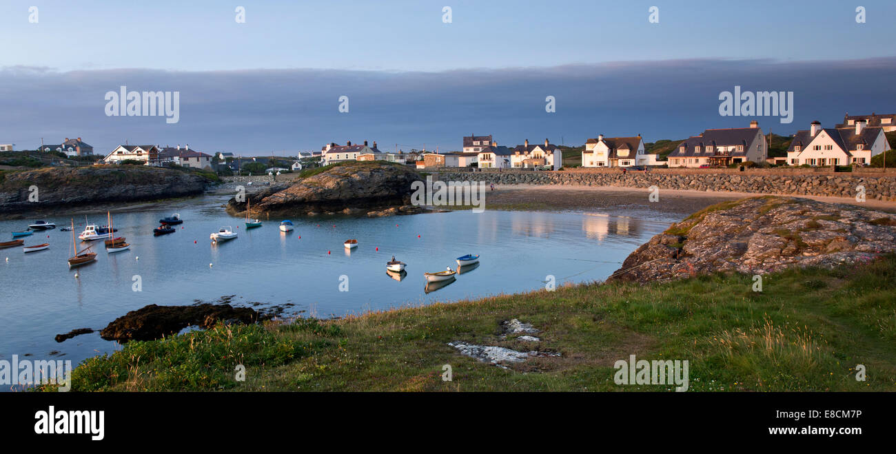 Porth Diana with houses of Trearddur Bay in late evening light on the western coast of Holy Island part of the Isle of Anglesey Stock Photo