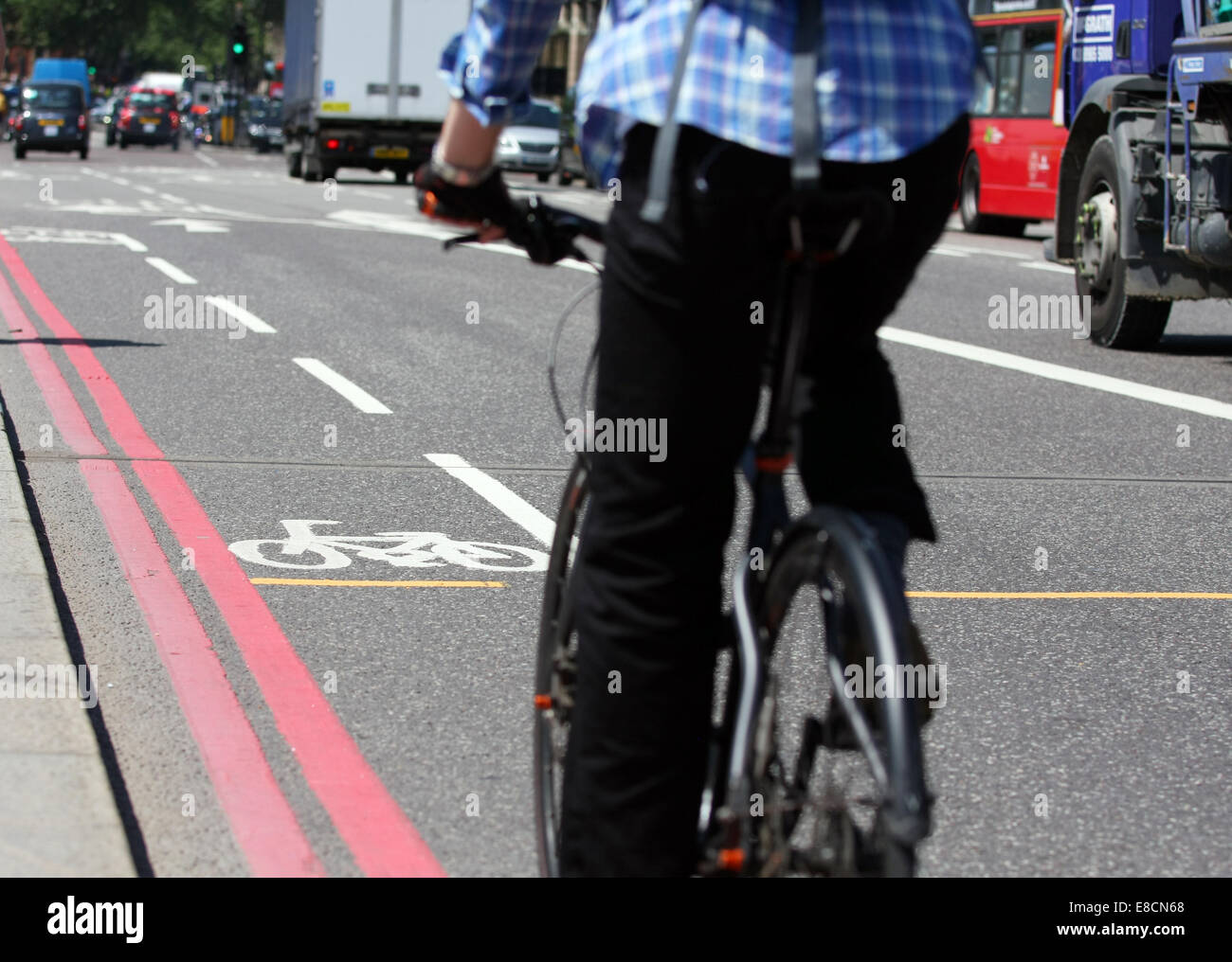 A cyclist approaching a cycle lane in a bus lane on Westminster Bridge in London, England Stock Photo