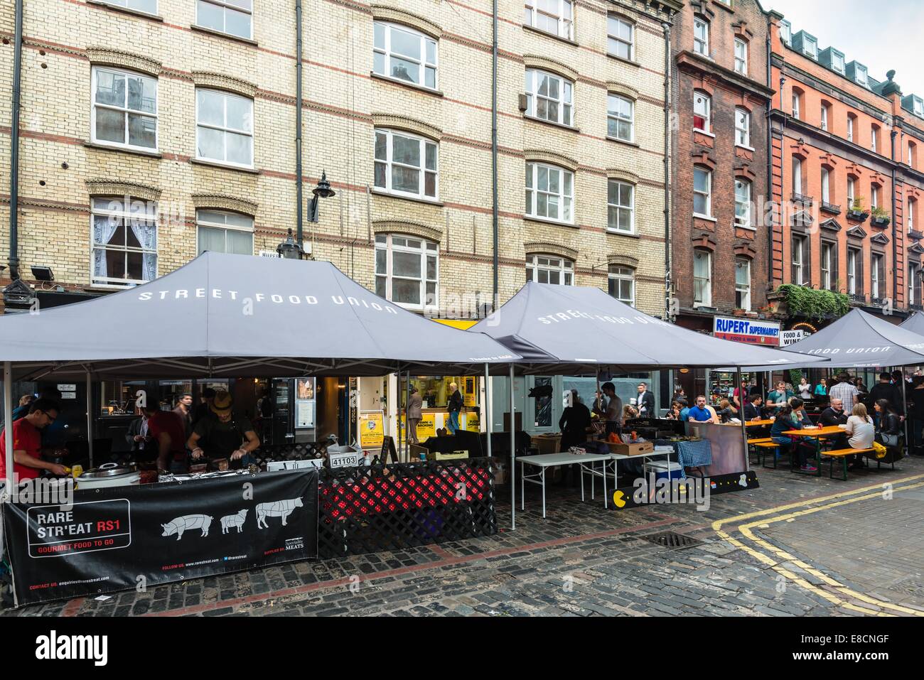 LONDON, UK - SEPTEMBER 26, 2014: People are buying freshly prepared finger food on the London Street Food Union market in Soho o Stock Photo