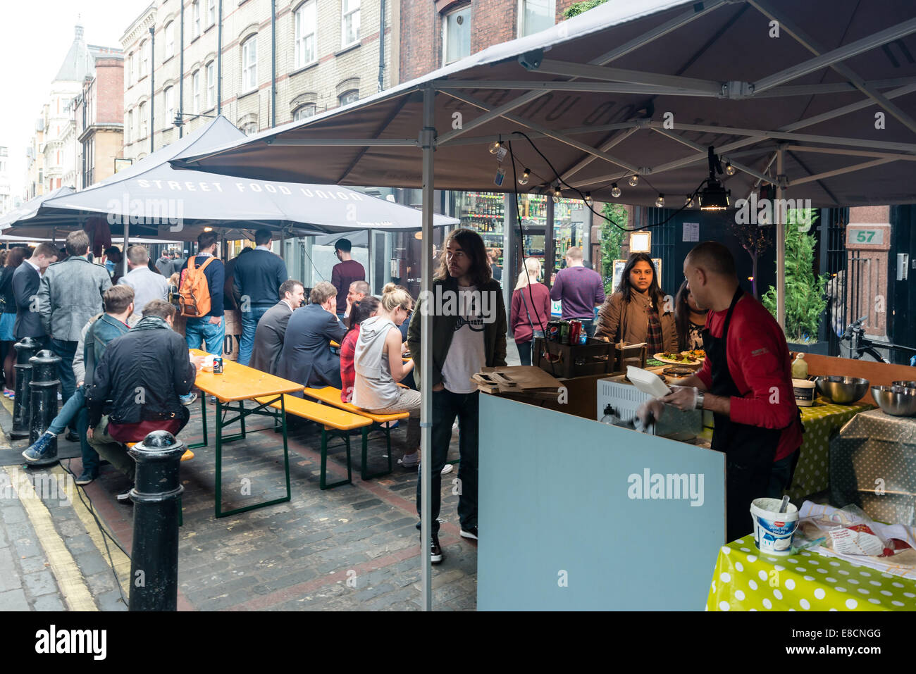 LONDON, UK - SEPTEMBER 26, 2014: People are buying freshly prepared finger food on the London Street Food Union market in Soho Stock Photo