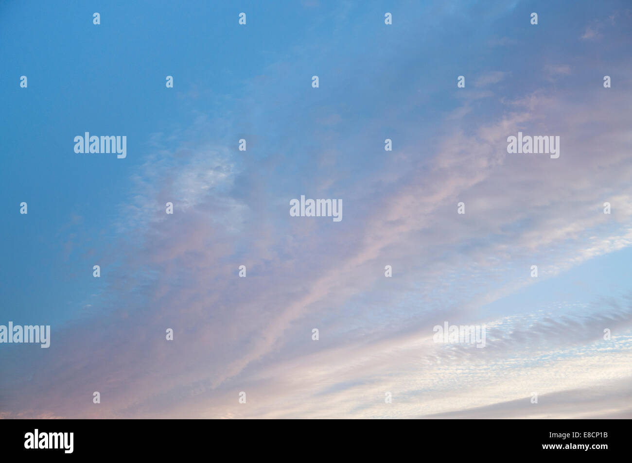 Sunlit pink clouds and blue sky at sunset Stock Photo - Alamy
