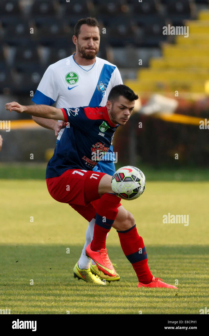 Budapest, Hungary. 5th Oct, 2014. Laszlo Pekar of Nyiregyhaza covers the  ball from Sandor Hidvegi of MTK (l) during MTK vs. Nyiregyhaza OTP Bank  League football match at Bozsik Stadium on October