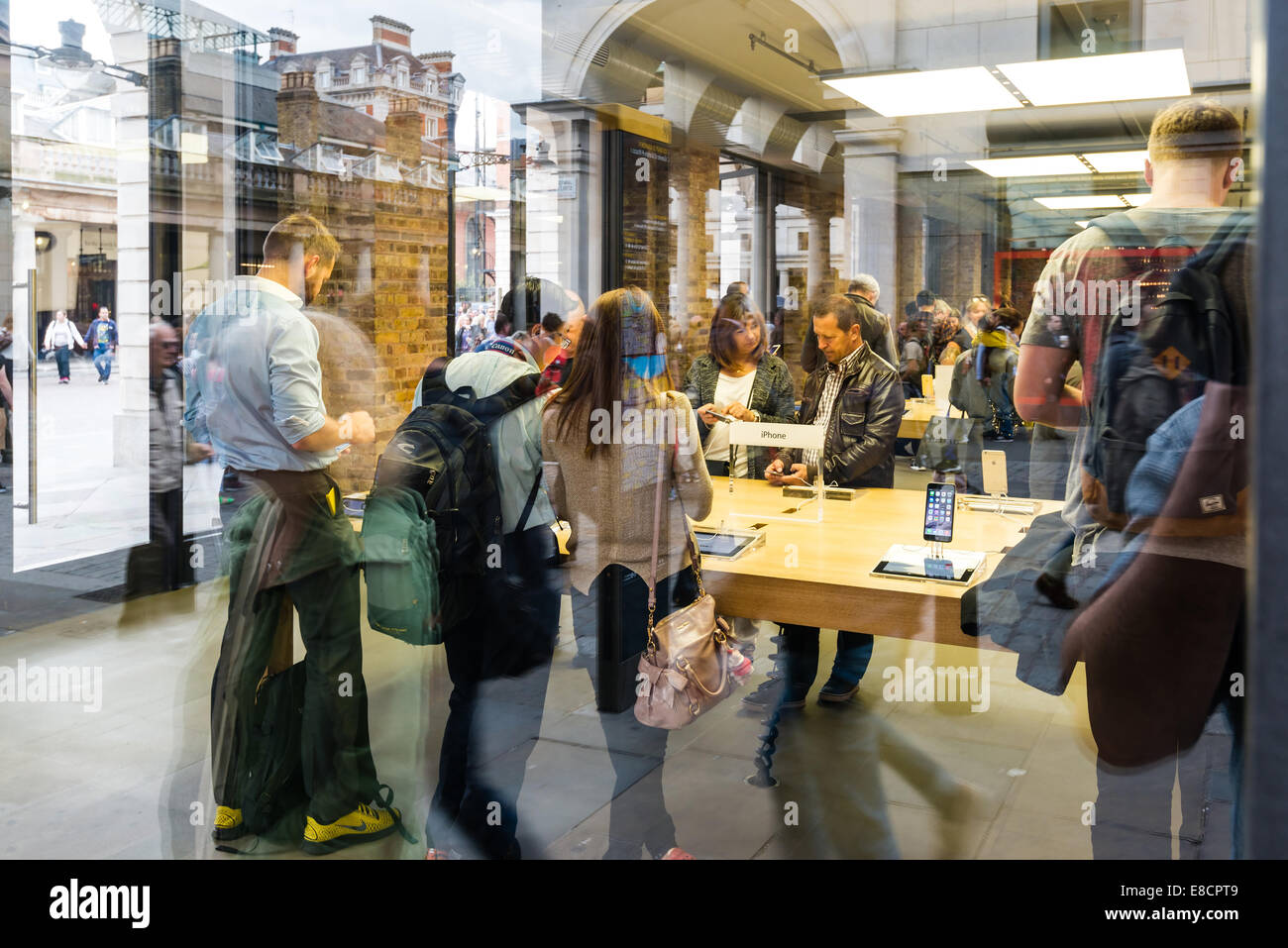 London, United Kingdom - September 26, 2014: Customers admiring the new Apple iPhone 6 and iPhone 6 Plus at the Apple Inc. store Stock Photo