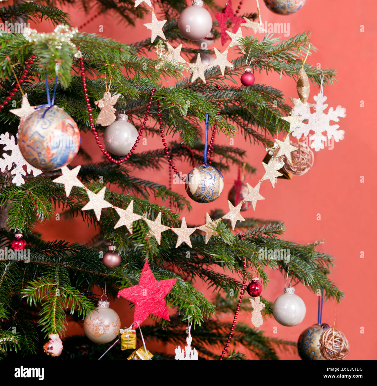 Christmas tree decorated with stars and painted Christmas baubles Stock Photo