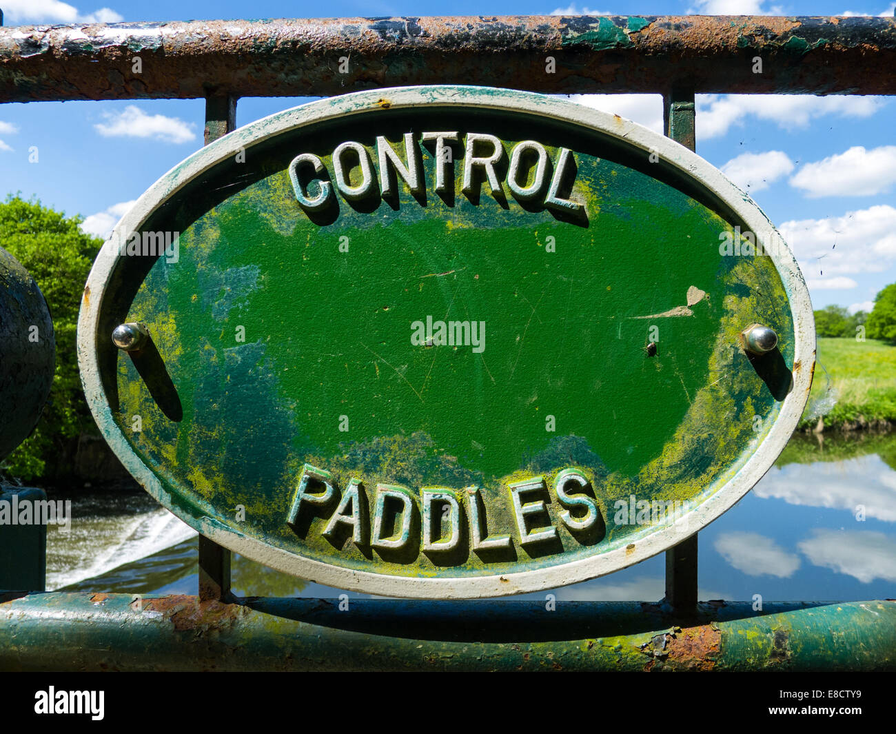 Control Paddles notice on weir railing Stock Photo