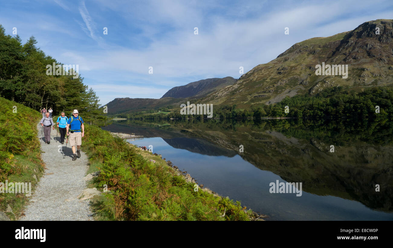Walkers alongside Lake Buttermere, Lake District, UK Stock Photo