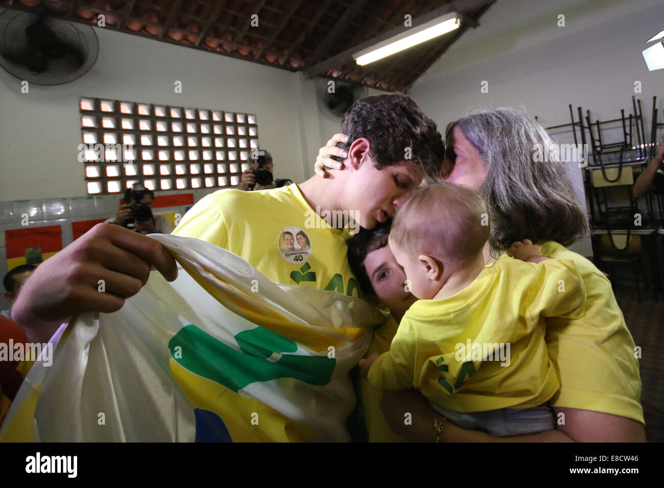 Recife, Brazil. 5th Oct, 2014. Renata Campos(R), widow of late presidential  candidate Eduardo Campos, hugs her sons after casting her ballot at a  polling center in Recife, Brazil, on Oct. 5, 2014.