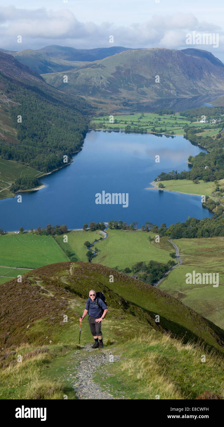 Walker above Buttermere Lake, Lake District, UK Stock Photo