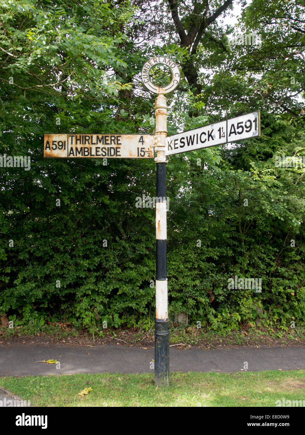 An old signpost in the Lake District with directions to Keswick, Thirlmere and Ambleside Stock Photo