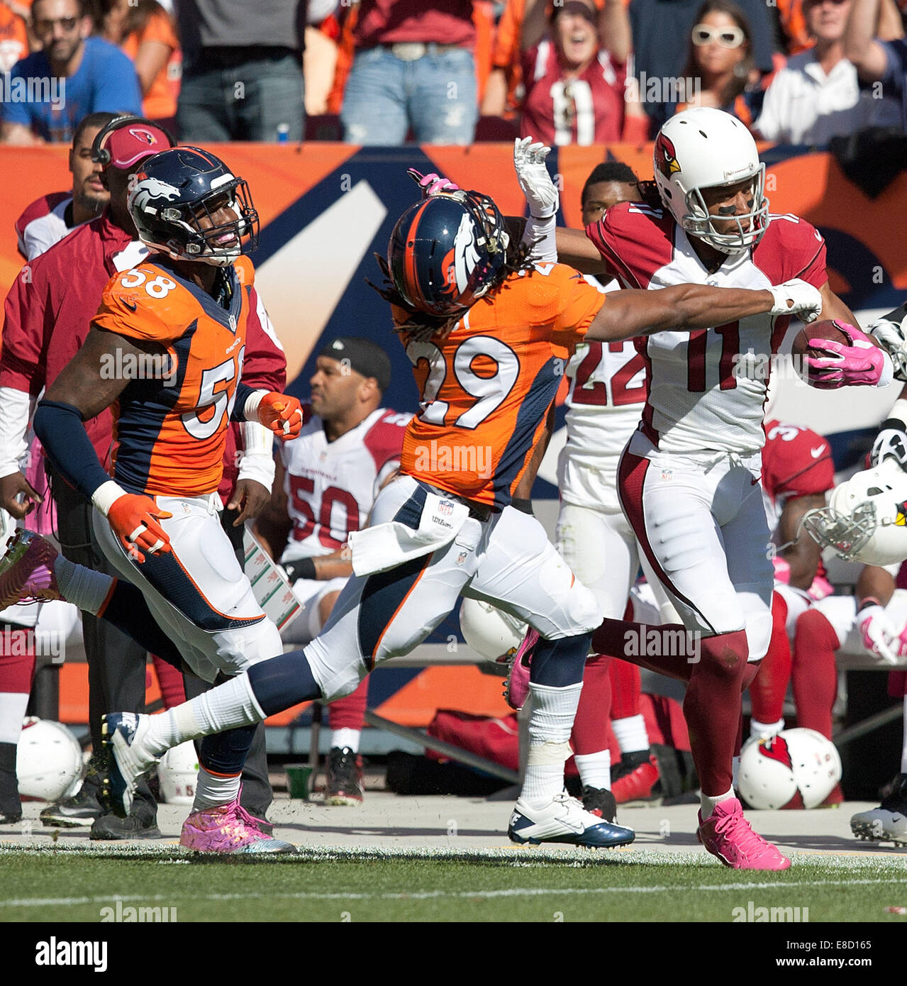 Denver, Colorado, USA. 5th Oct, 2014. Cardinals WR LARRY FITZGERALD, right, catches a pass over Broncos CB BRADLEY ROBY, center, during the 1st. half at Sports Authority Field at Mile High Sunday afternoon. The Broncos beat the Cardinals 41-20. Credit:  Hector Acevedo/ZUMA Wire/Alamy Live News Stock Photo