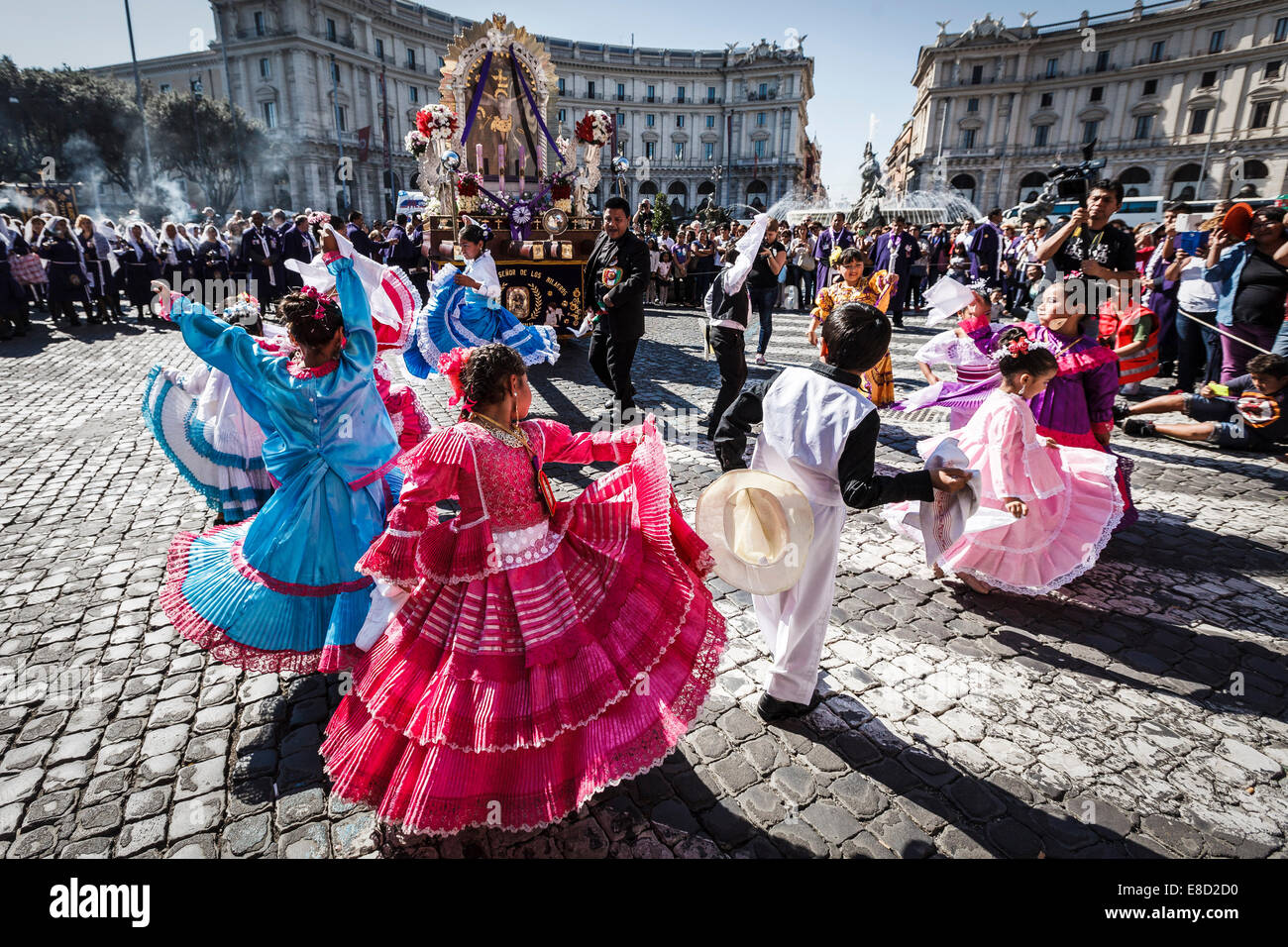 Children dressed in traditional costumes dance while participating in a  procession in Rome honoring, Peru's most revered Catholic religious icon,  the "Lord of Miracles" or "Seor de los Milagros". The Peruvian community