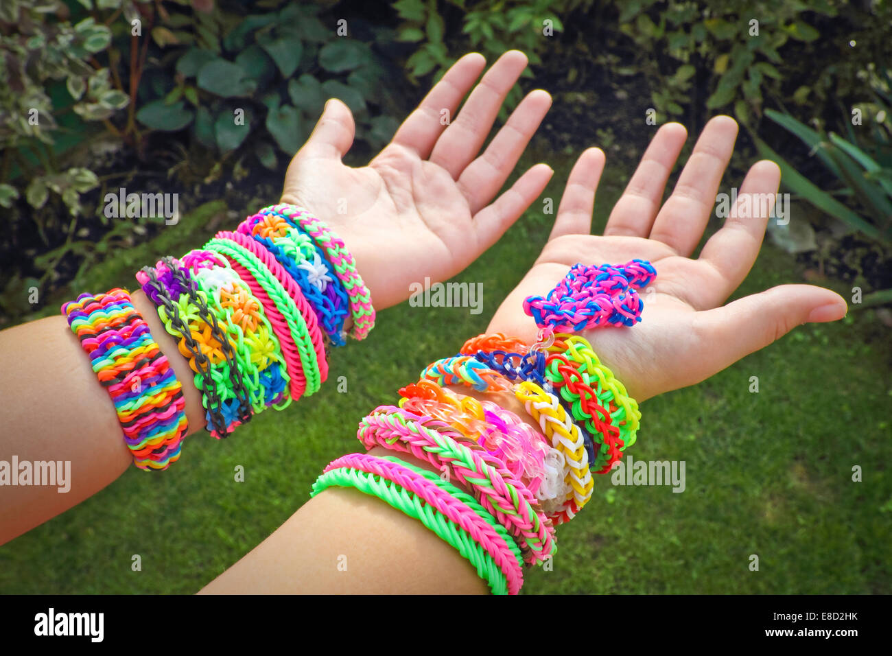 Rubber bands on hand. Girls hand with bracelets made of rubber bands.  Rainbow loom colored rubber bands Stock Photo - Alamy