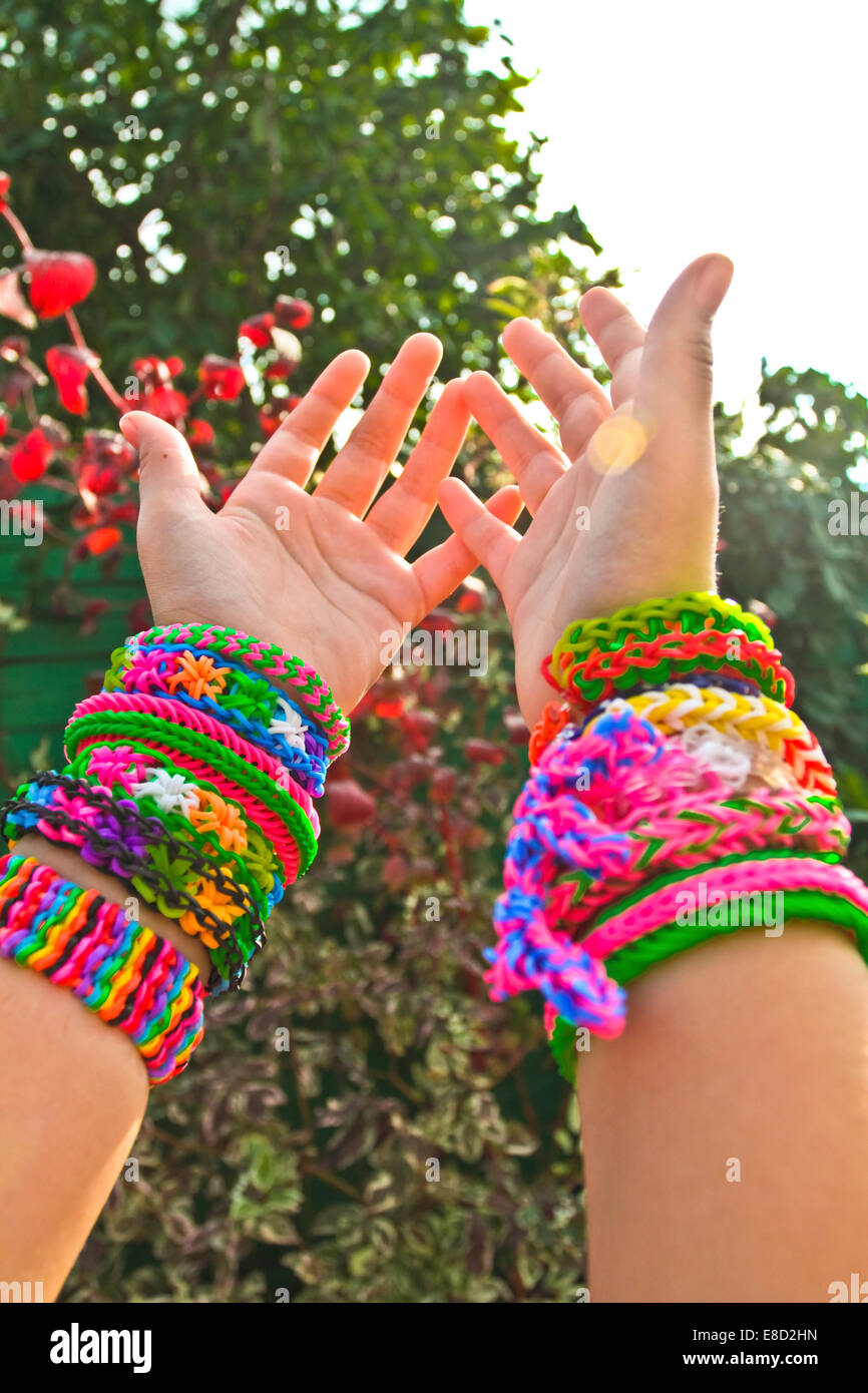 Rubber bands on hand. Girls hand with bracelets made of rubber bands.  Rainbow loom colored rubber bands Stock Photo - Alamy