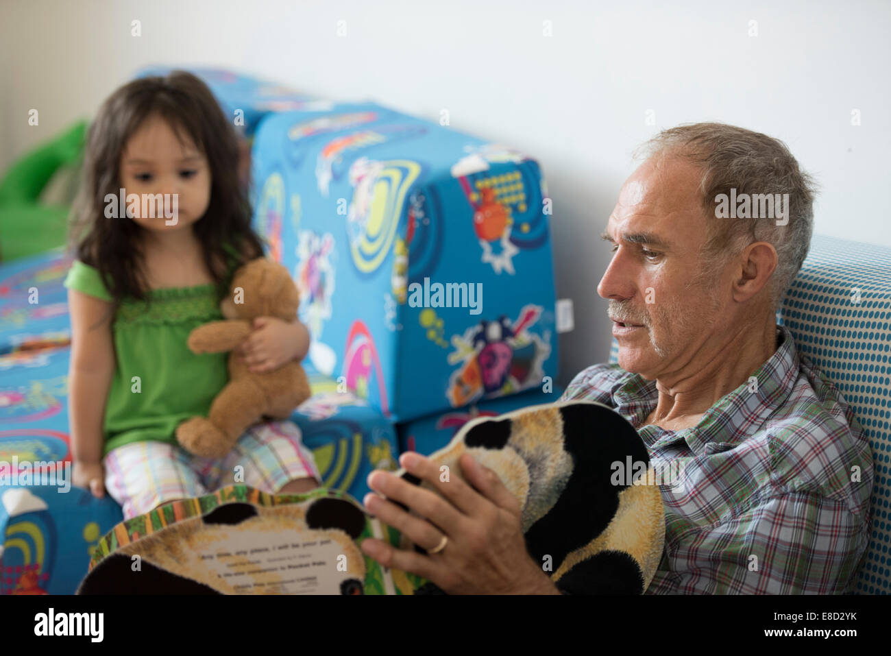 Grandparent reading to grandchild Stock Photo