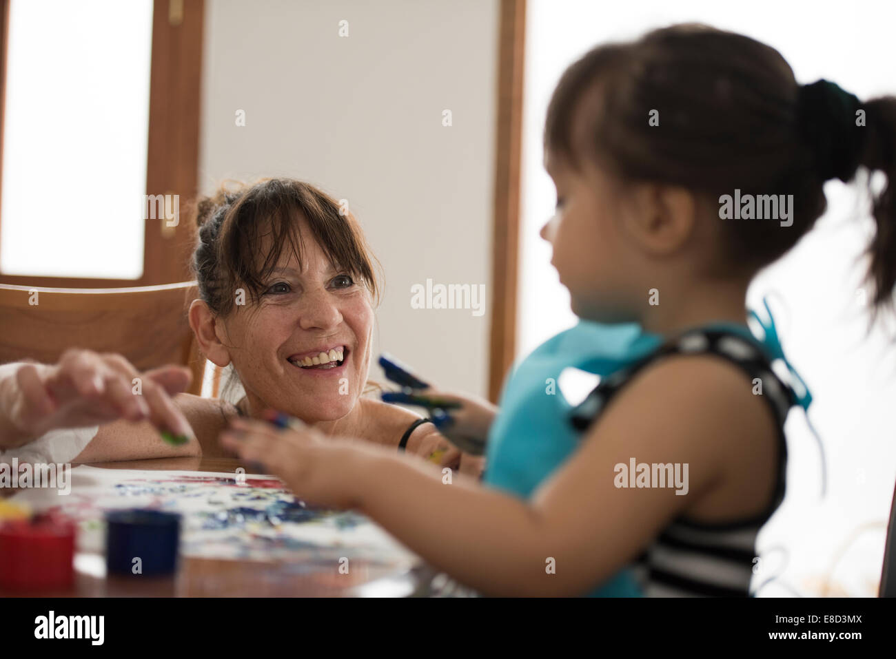 Grandmother finger painting with grandchild Stock Photo