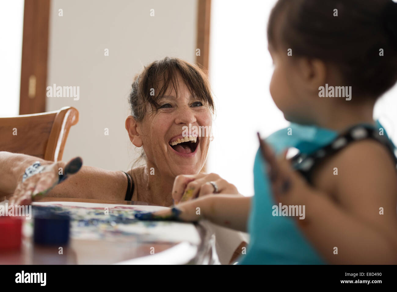 Grandmother finger painting with grandchild Stock Photo