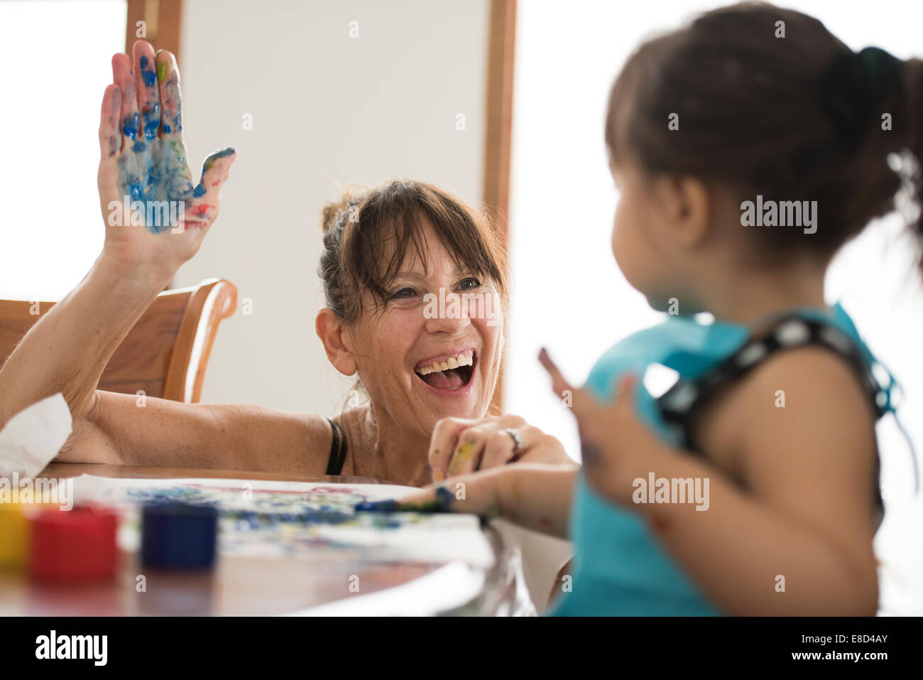 Grandmother finger painting with grandchild Stock Photo