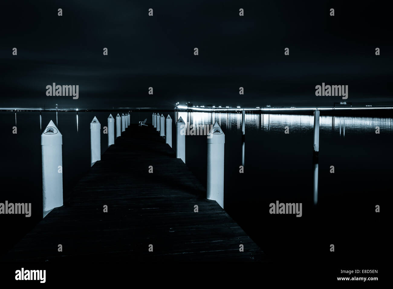 A pier and the Chesapeake Bay Bridge at night, in Kent Island, Maryland. Stock Photo