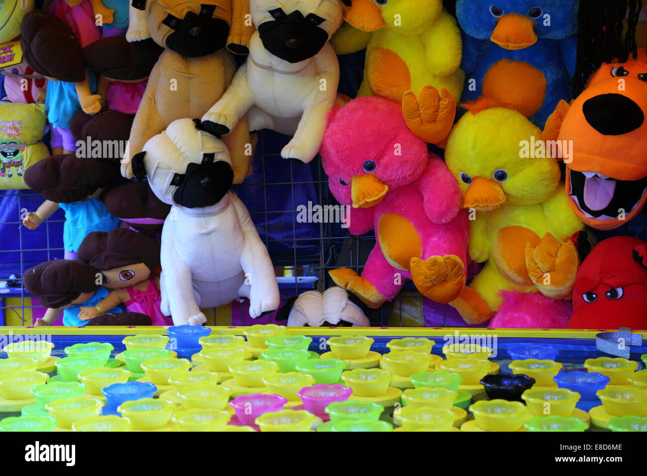Stuffed toy prizes at a sideshow alley stall lure people to play at the Perth Royal Show