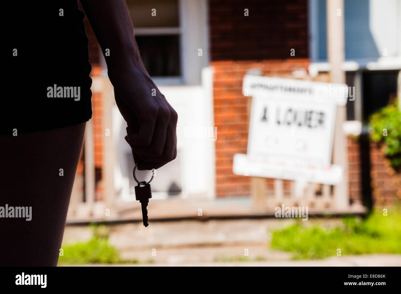 Young Woman standing with keys in front of her new apartment Stock ...