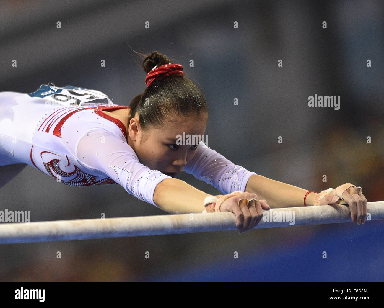 Nanning, China's Guangxi Zhuang Autonomous Region. 6th Oct, 2014. Chinese gymnast Yao Jinnan performs on the uneven bars during the women's qualifying round of the 45th Gymnastics World Championships in Nanning, capital of south China's Guangxi Zhuang Autonomous Region, Oct. 6, 2014. The 45th FIG Artistic Gymnastics World Championships lasts from Oct. 3 to 12 in Nanning. Credit:  Li Qiaoqiao/Xinhua/Alamy Live News Stock Photo