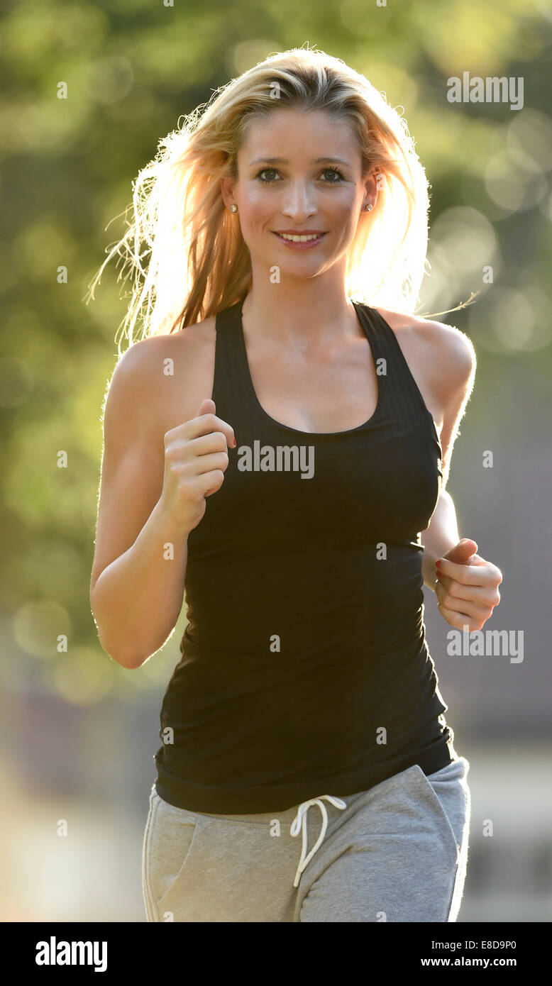 Young woman jogging, Germany Stock Photo