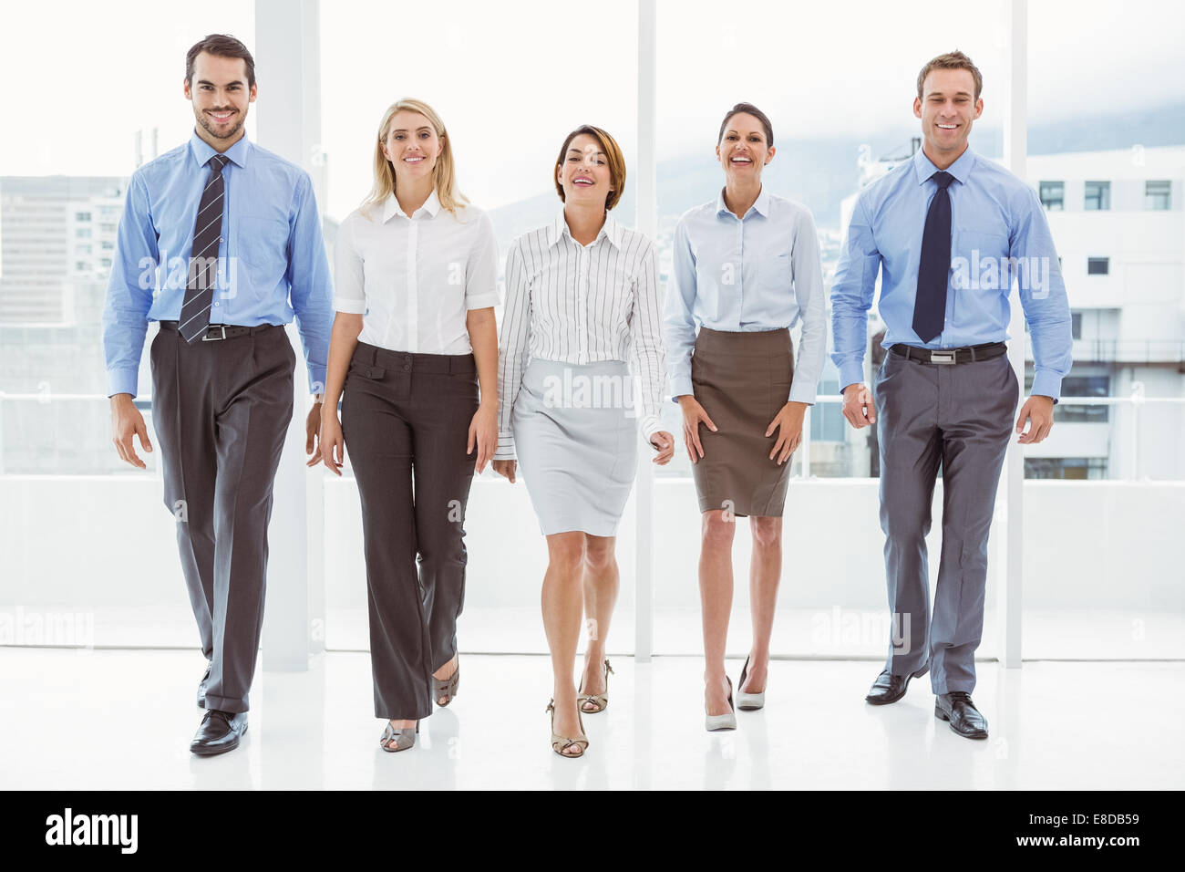 Business people walking together in office Stock Photo