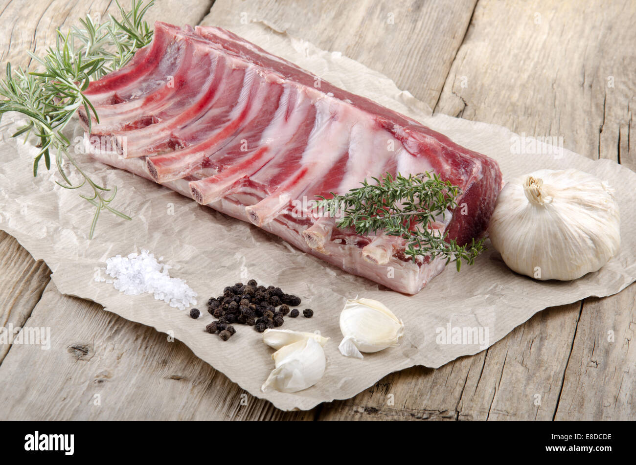 Raw French Rack raw rack of lamb french style with thyme, garlic, pepper, coarse salt ...