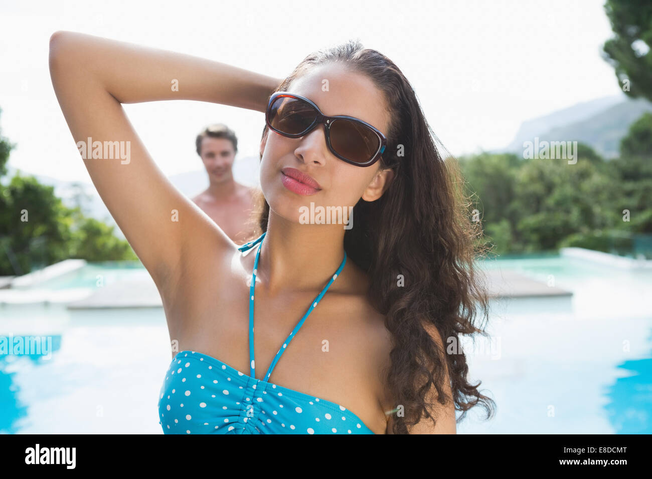 Beautiful young woman by swimming pool Stock Photo