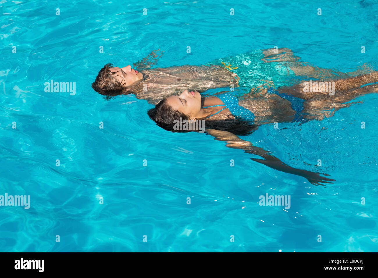 Relaxed young couple in swimming pool Stock Photo
