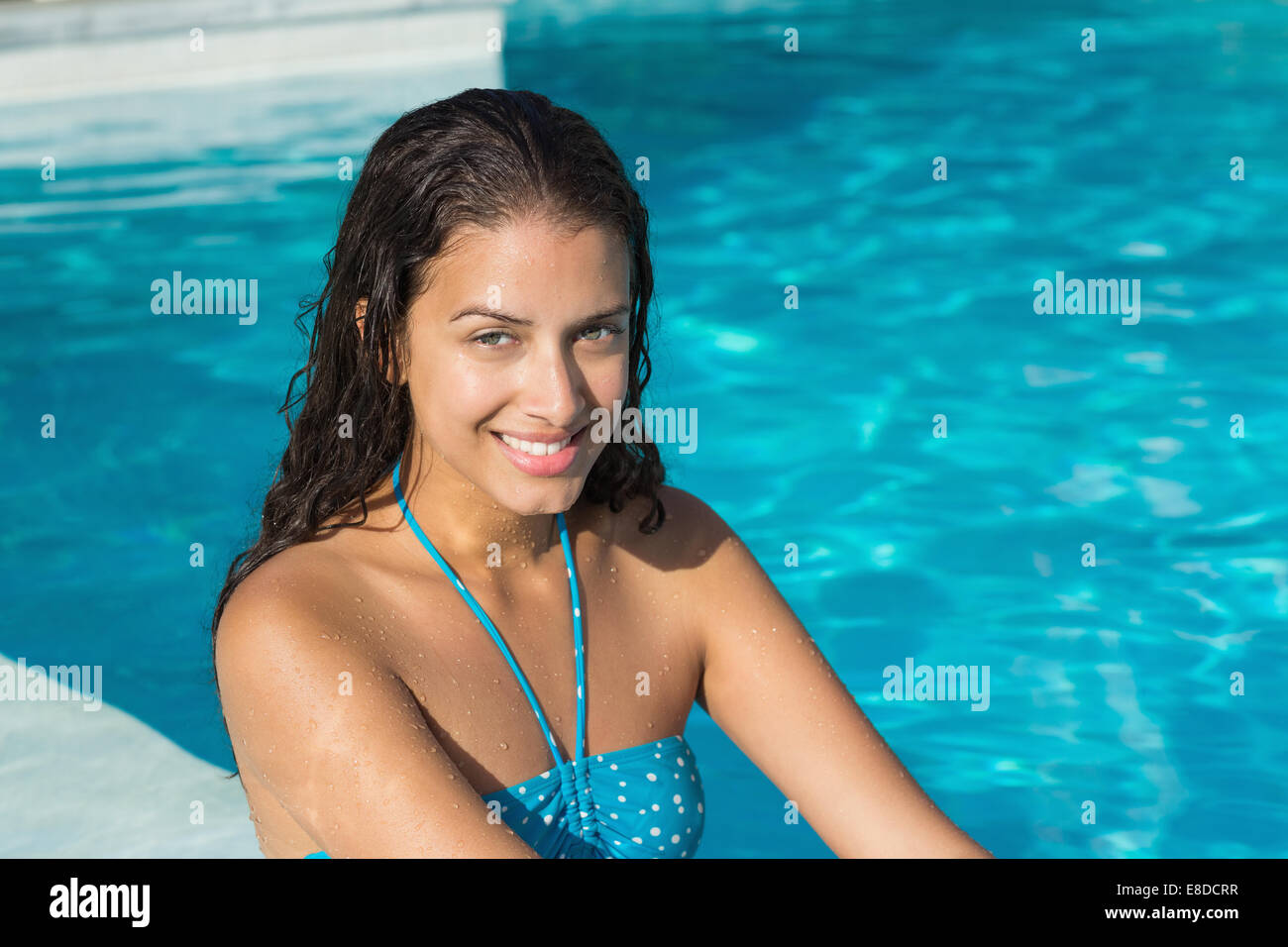 Portrait of a beautiful young woman by swimming pool Stock Photo