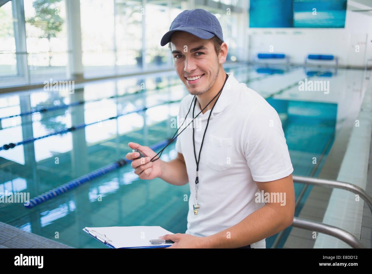 Handsome swimming instructor smiling at camera Stock Photo Alamy