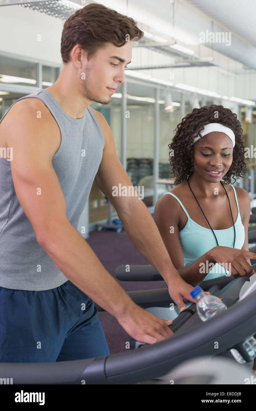 Personal trainer showing woman treadmill hi-res stock photography and ...
