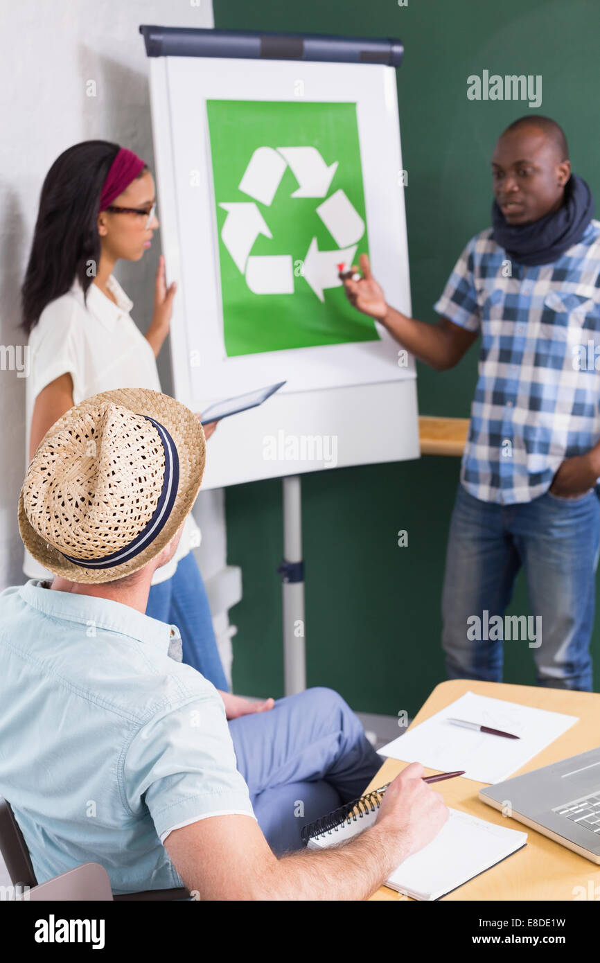 Creative meeting with recycling symbol on whiteboard Stock Photo