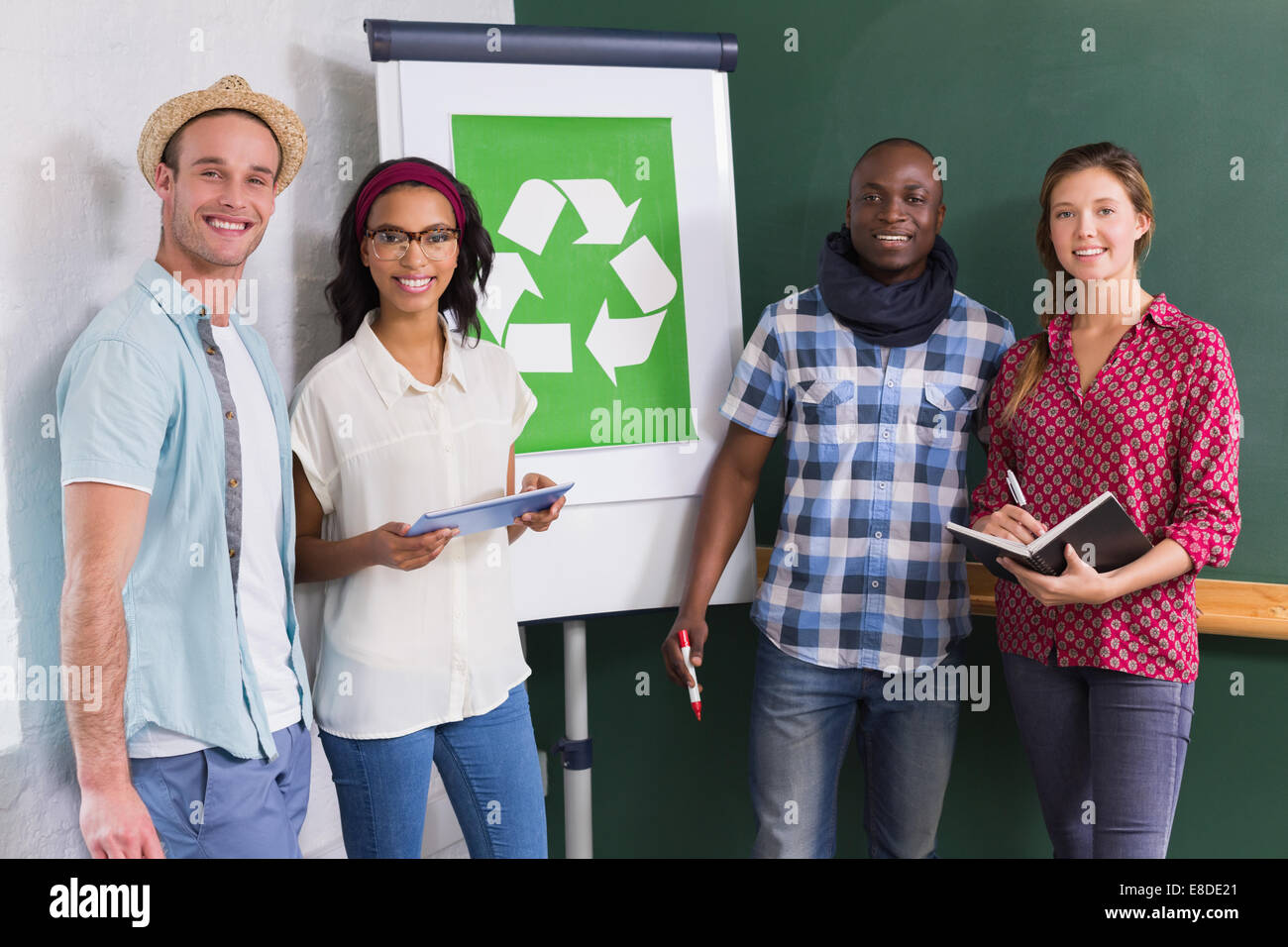 Creative colleagues with recycling symbol on whiteboard Stock Photo Alamy