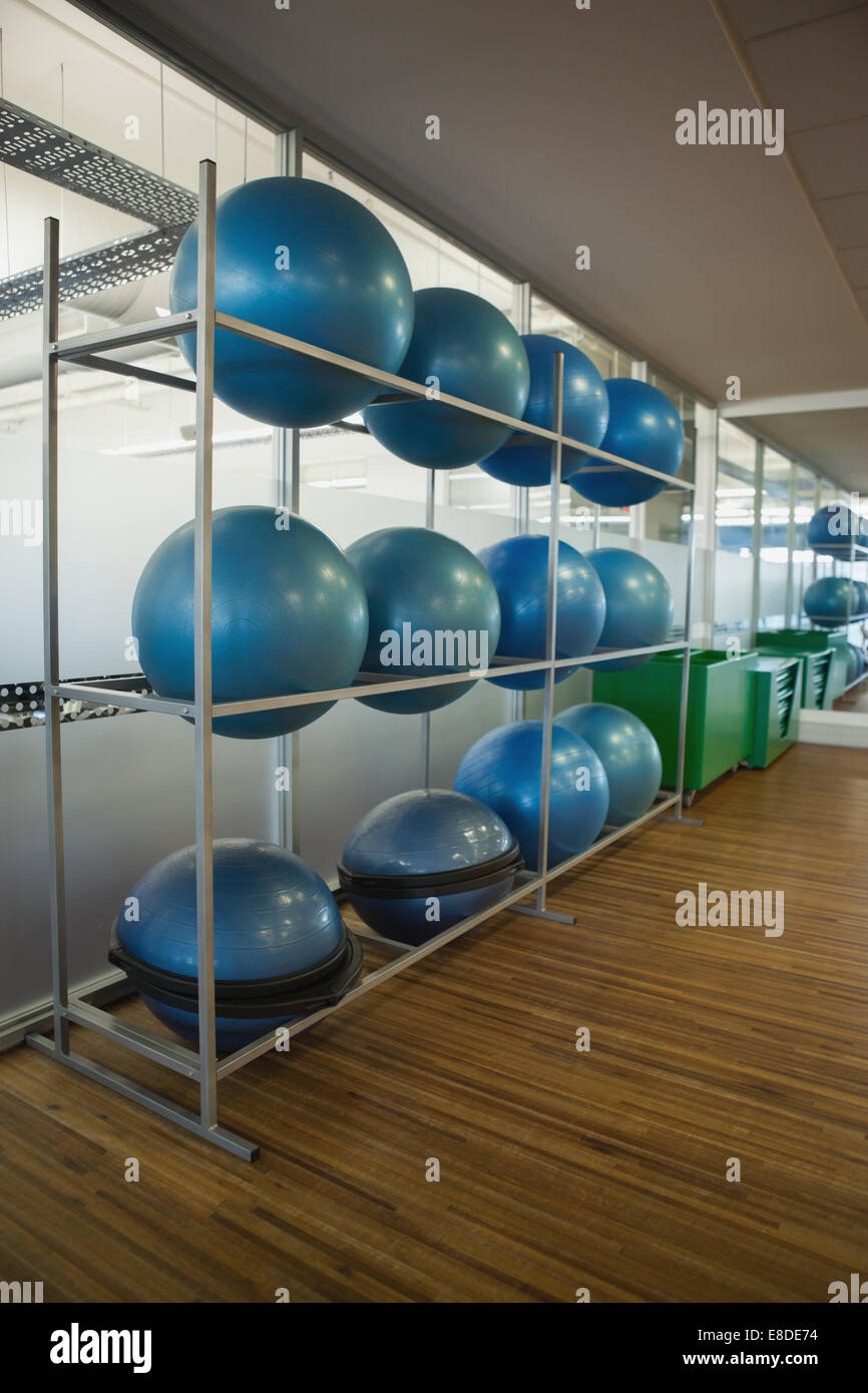 Exercise balls on rack in studio Stock Photo - Alamy