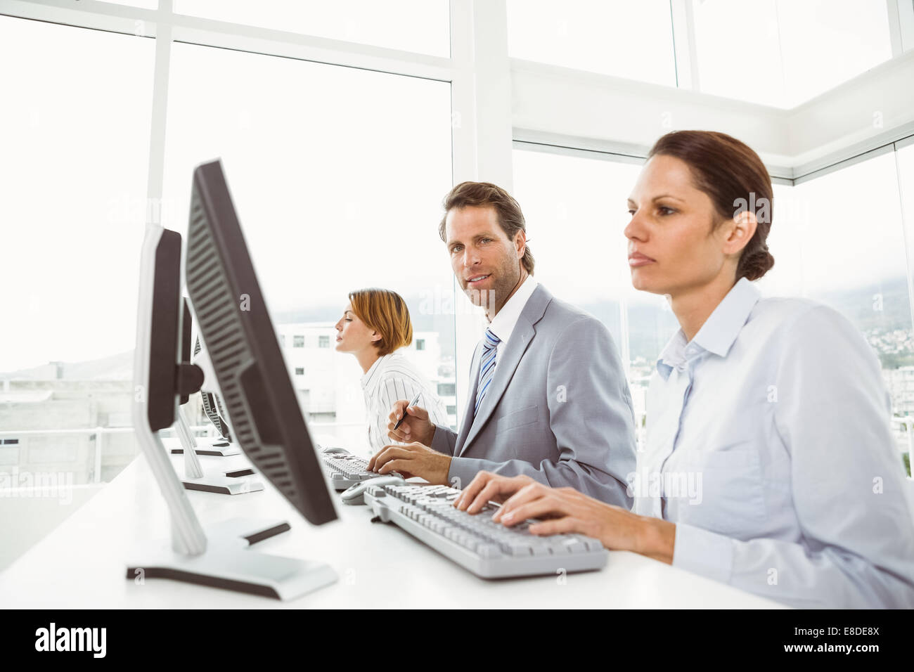 Business people using computers in office Stock Photo - Alamy