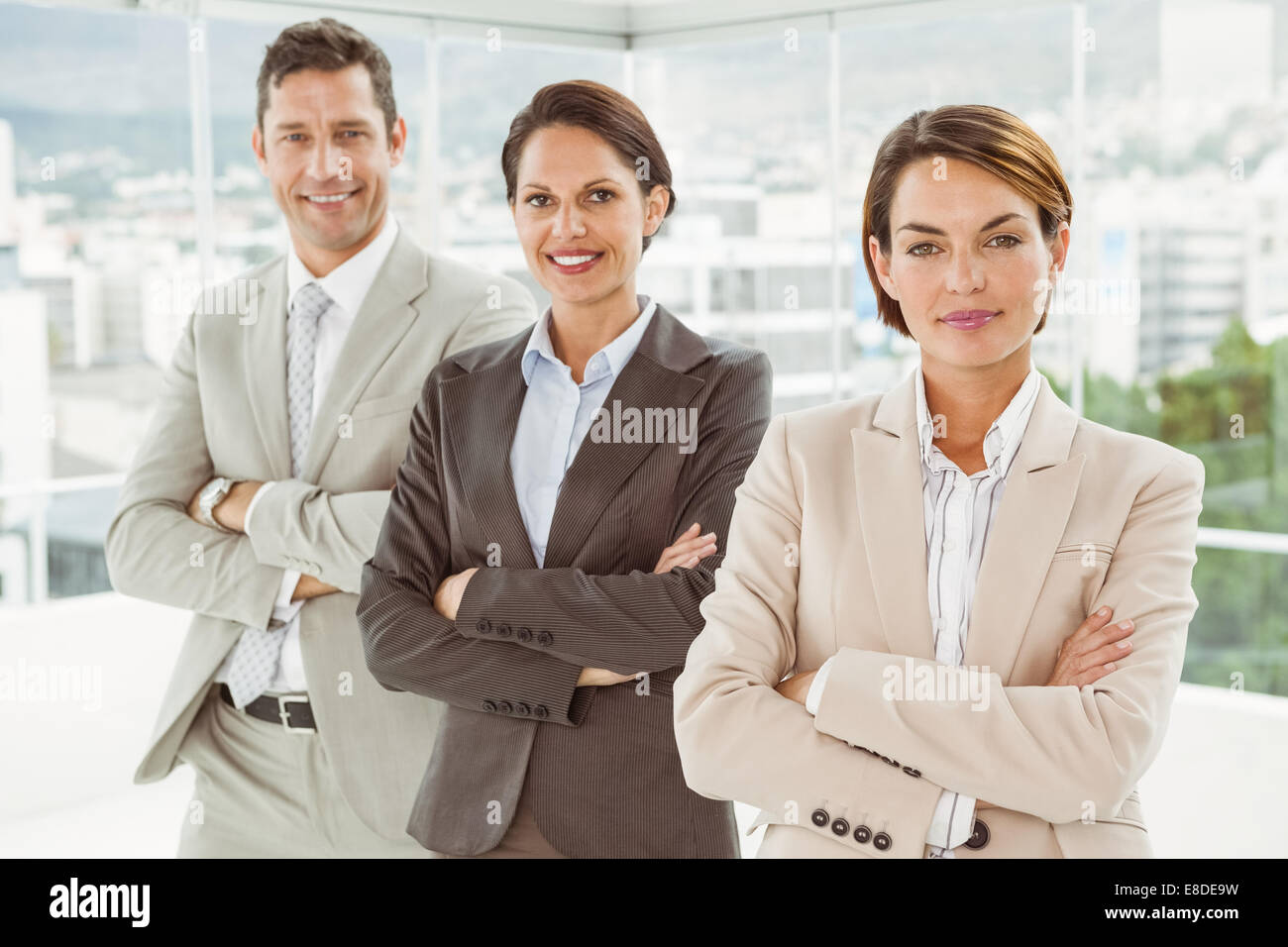 Confident business people with arms crossed in office Stock Photo - Alamy