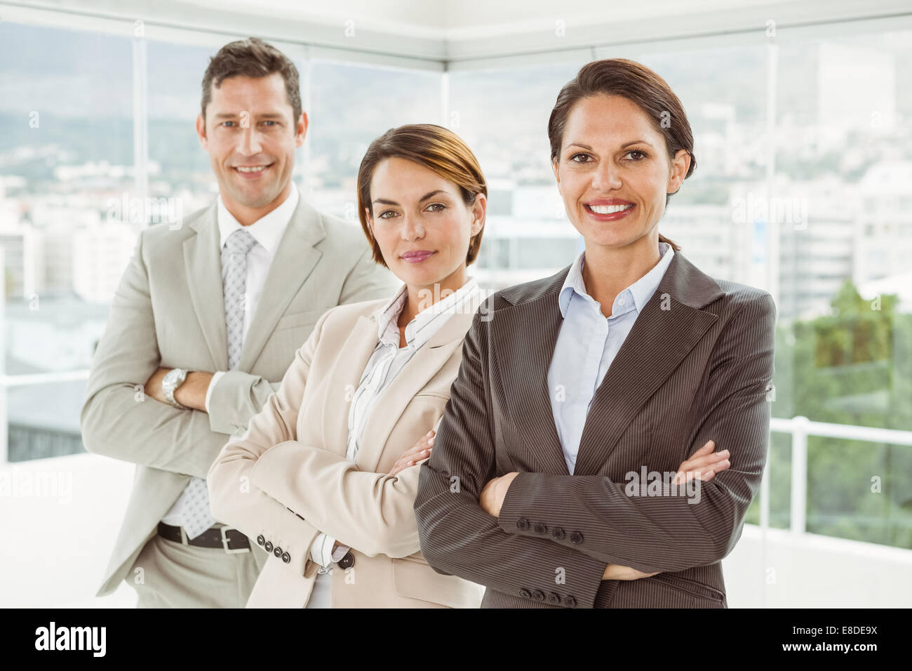 Confident business people with arms crossed in office Stock Photo - Alamy