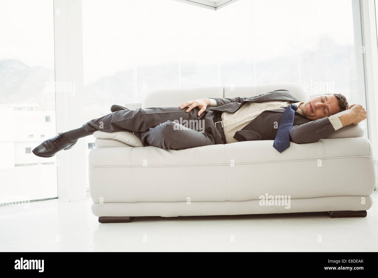 Businessman Sleeping On Couch In Living Room Stock Photo 74055371