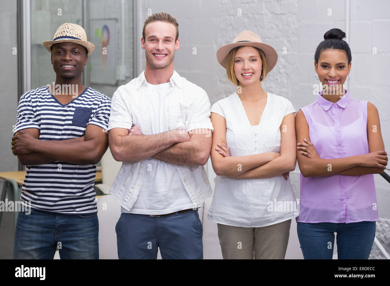 Creative business people with arms crossed in office Stock Photo - Alamy