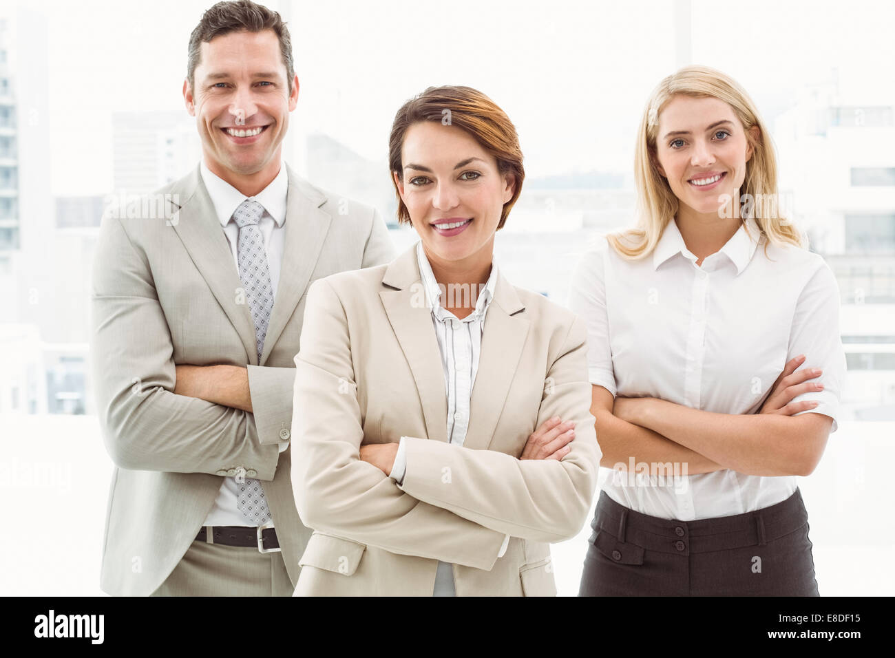 Happy business people with arms crossed in office Stock Photo - Alamy