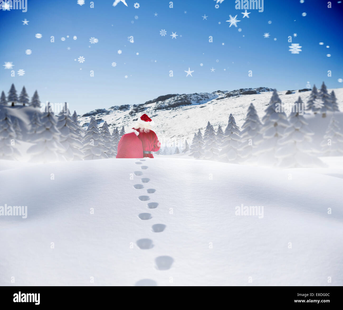 Composite image of santa walking in the snow Stock Photo