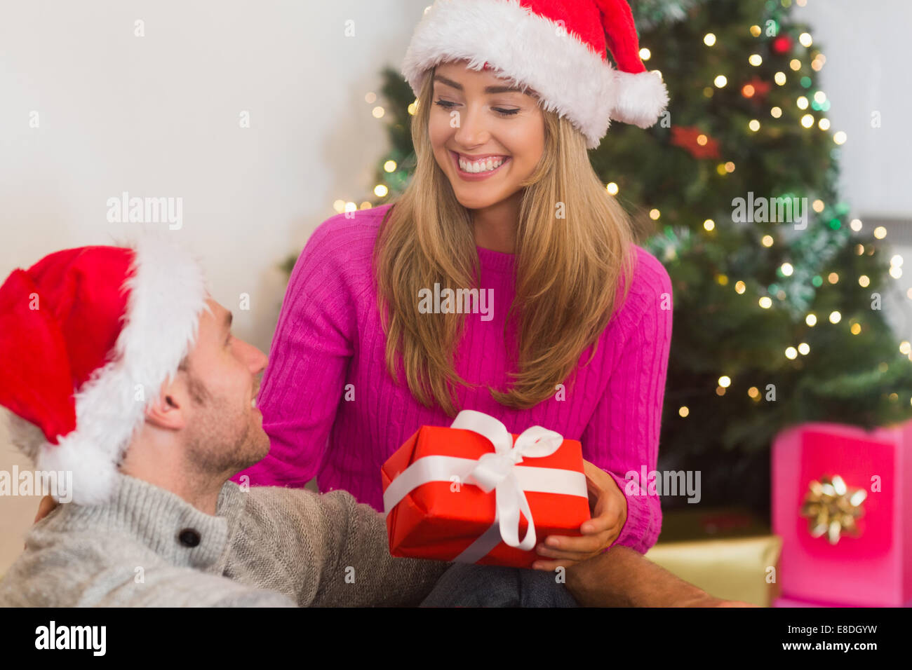 Sitting couple giving each other presents Stock Photo
