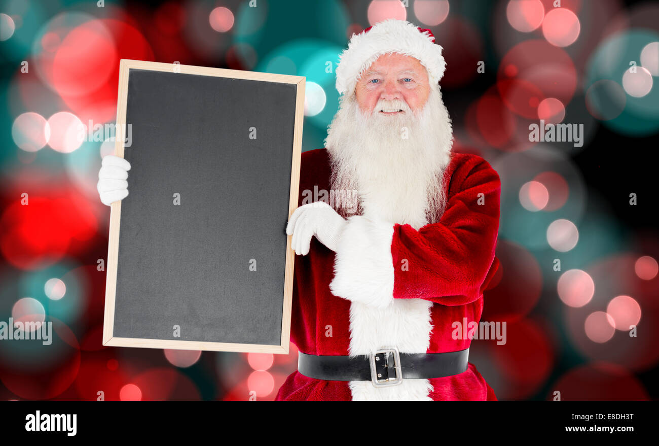 Composite image of santa claus showing blackboard Stock Photo - Alamy